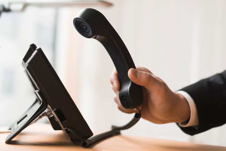 businessman-holding-headset businessman-holding-headset