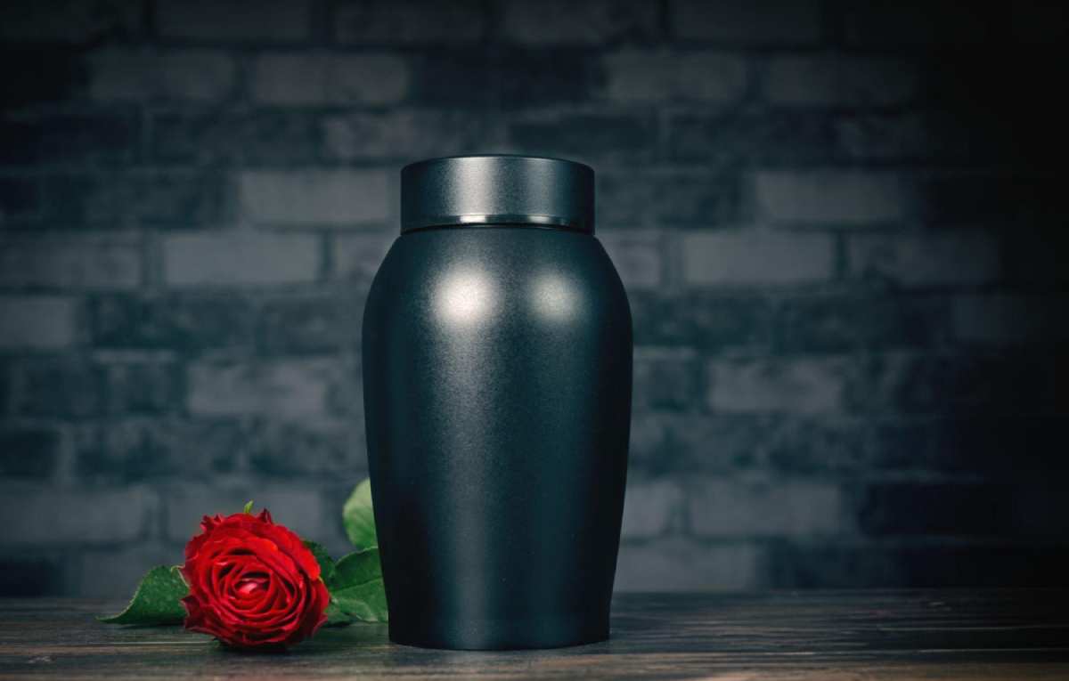 urn next to a rose flower